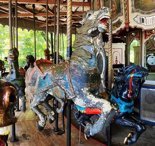 A carousel with horses and a bell
AI-generated content may be incorrect.