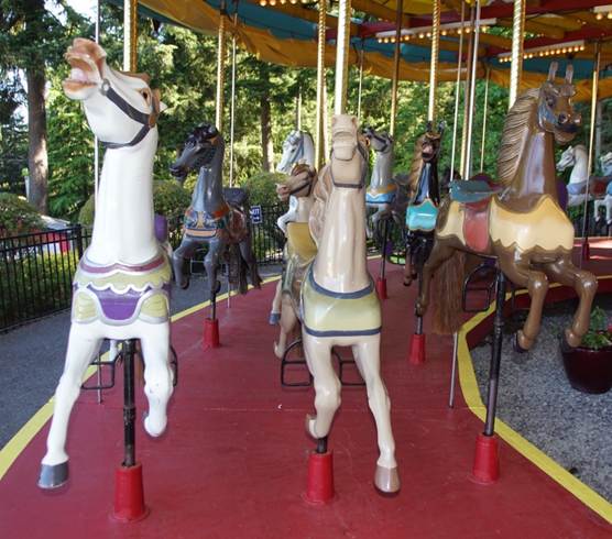 A person standing in front of a carousel

Description automatically generated