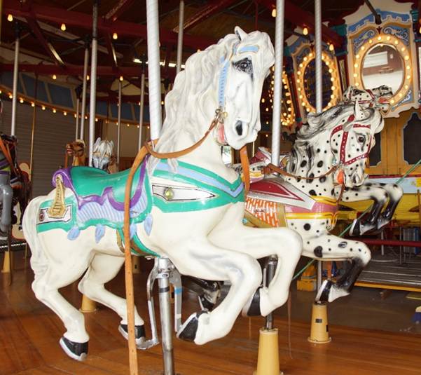 A picture containing carousel, ride, outdoor object, floor

Description automatically generated