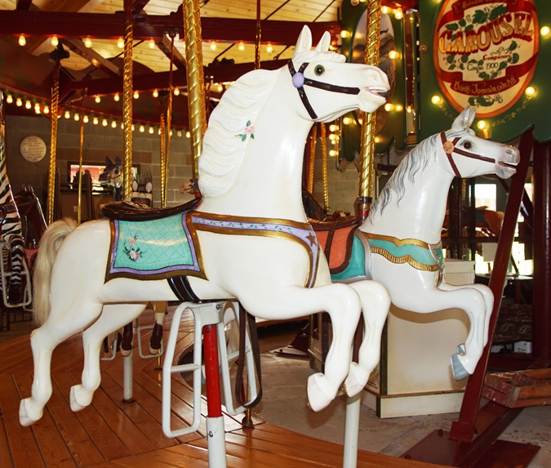 A picture containing carousel, ride, outdoor object, floor

Description automatically generated