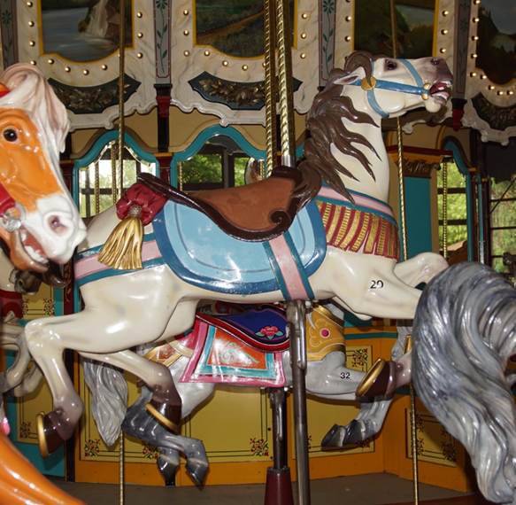 A group of people in a carousel

Description automatically generated