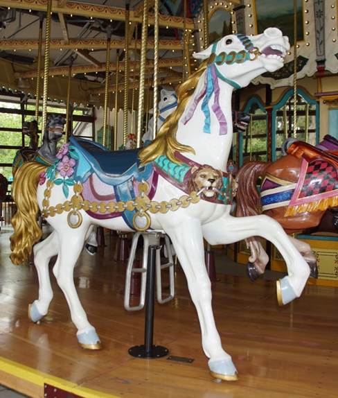 A person standing in front of a carousel

Description automatically generated