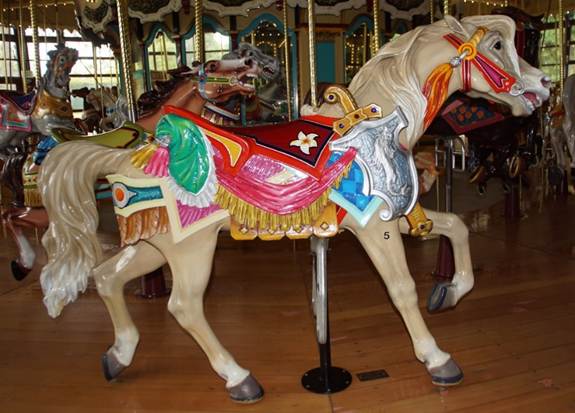 A person standing in front of a carousel

Description automatically generated