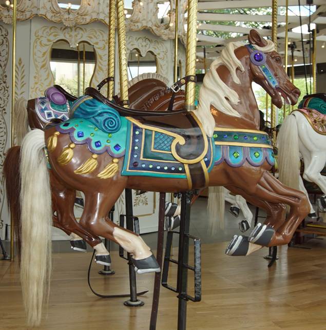 A picture containing carousel, floor, outdoor object, ride

Description automatically generated